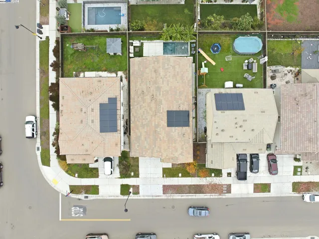an aerial view of residential house with outdoor space and parking