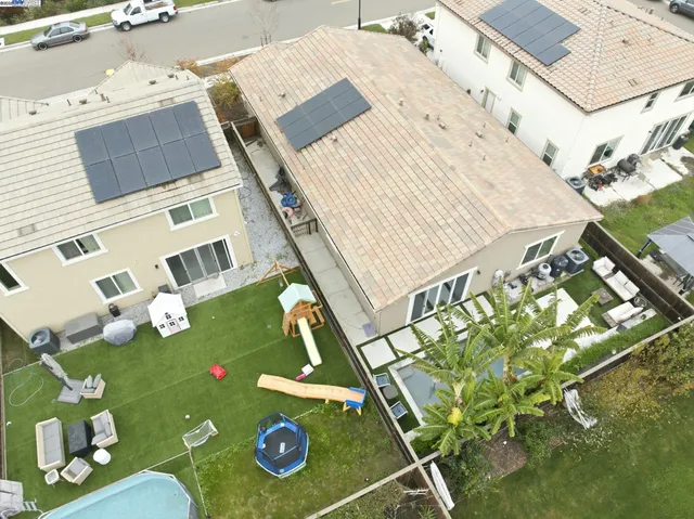 an aerial view of a house with a yard
