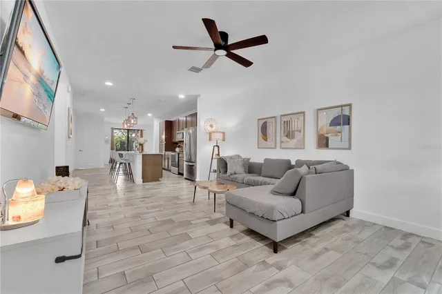a living room with furniture and kitchen view