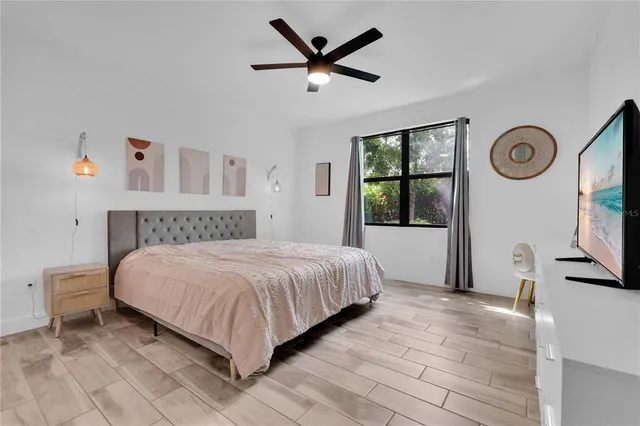 a bedroom with a large bed and a large window