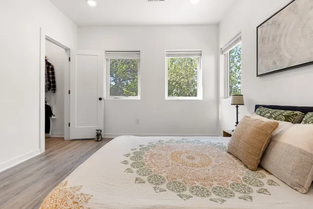 a bedroom with a large bed and a window