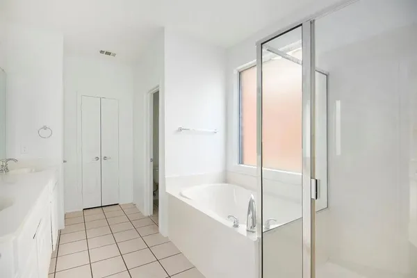 a bathroom with a bathtub and shower