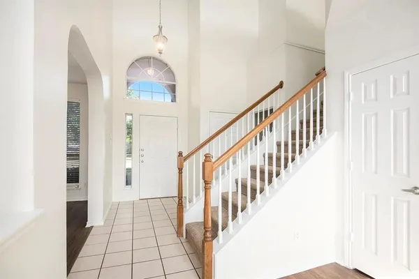 a view of a hallway with windows and stairs