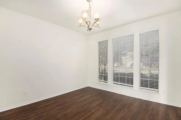 a view of a livingroom with wooden floor and a large window
