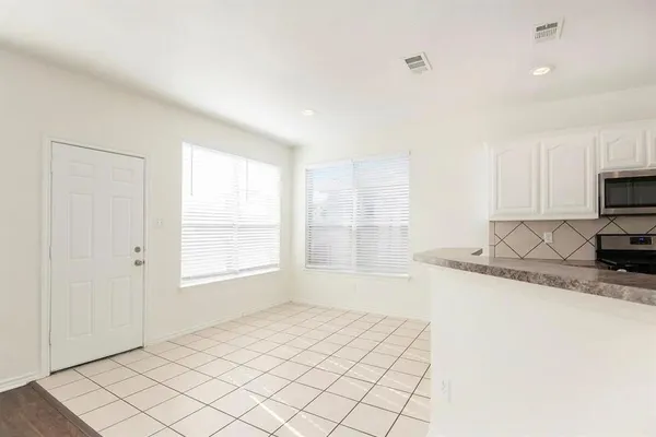 a kitchen with granite countertop a sink and a stove top oven