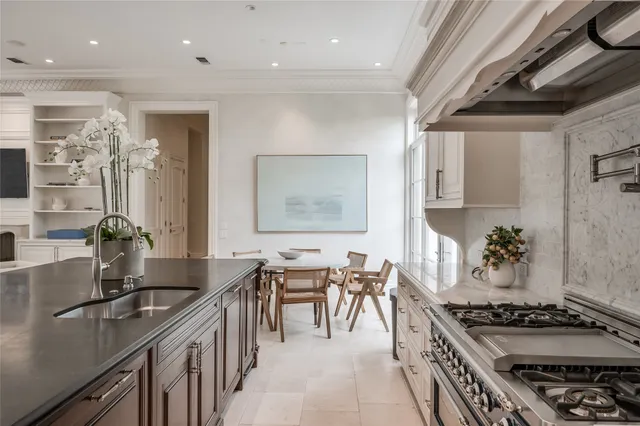 a kitchen with stove and cabinets