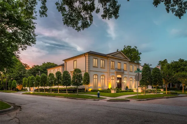 a view of a big house in a big yard with large trees