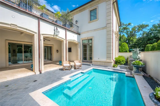 a backyard of a house with outdoor seating