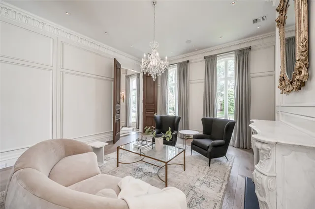 a living room with furniture and a chandelier