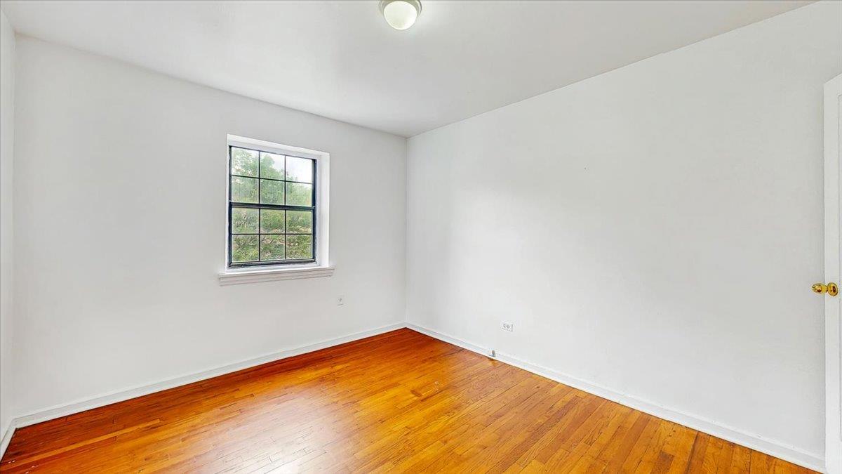 144-15 78th Road, Unit 3A Queens, NY 11367 - Photo 16 of 26 Unfurnished room featuring wood-type flooring