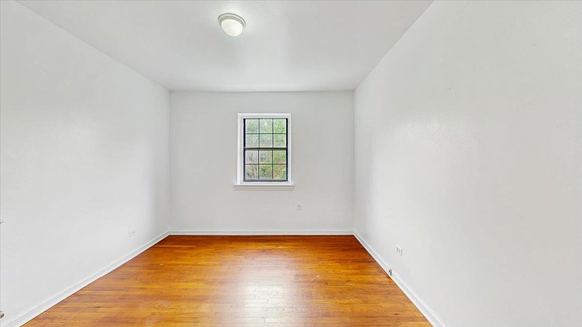 144-15 78th Road, Unit 3A Queens, NY 11367 - Photo 17 of 26 Unfurnished room featuring light wood-style floors and baseboards