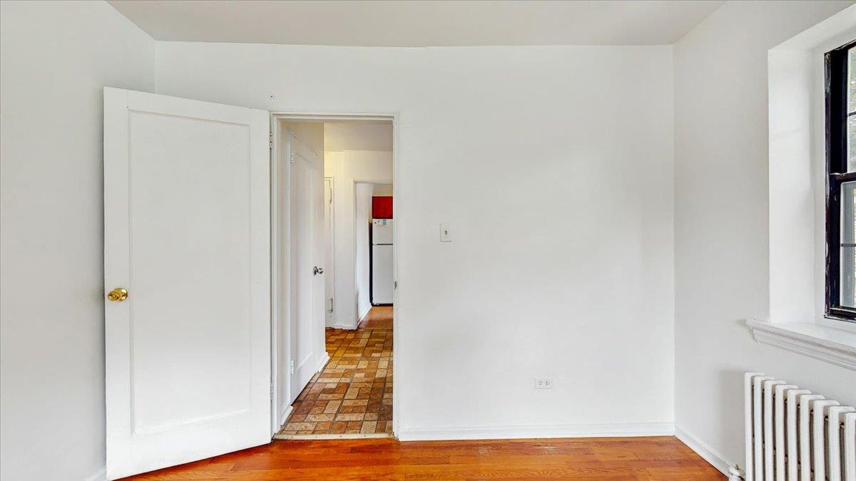 144-15 78th Road, Unit 3A Queens, NY 11367 - Photo 18 of 26 Spare room with radiator and baseboards