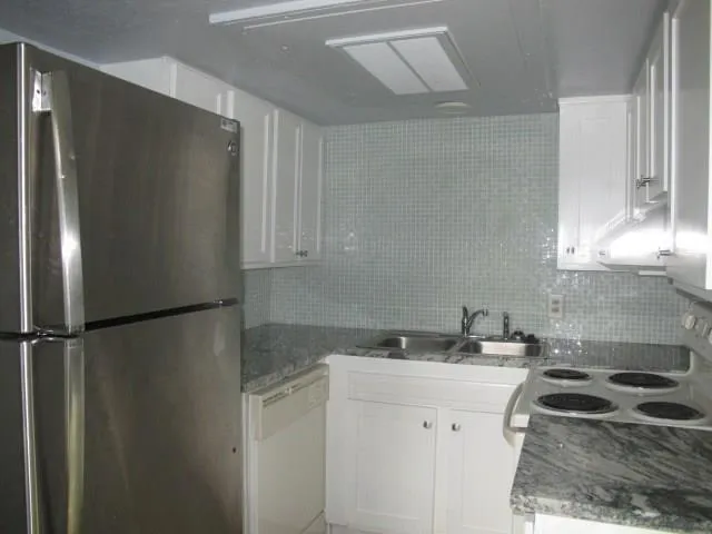 a kitchen with a sink and a refrigerator