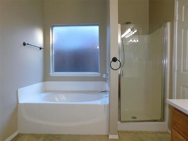 a bathroom with a tub and a shower