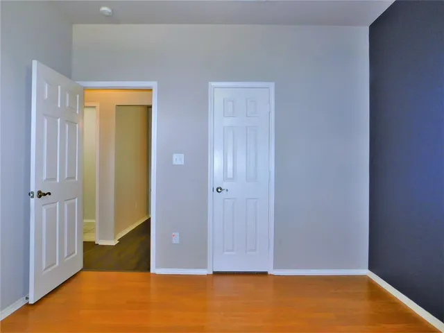 an empty room with closet area
