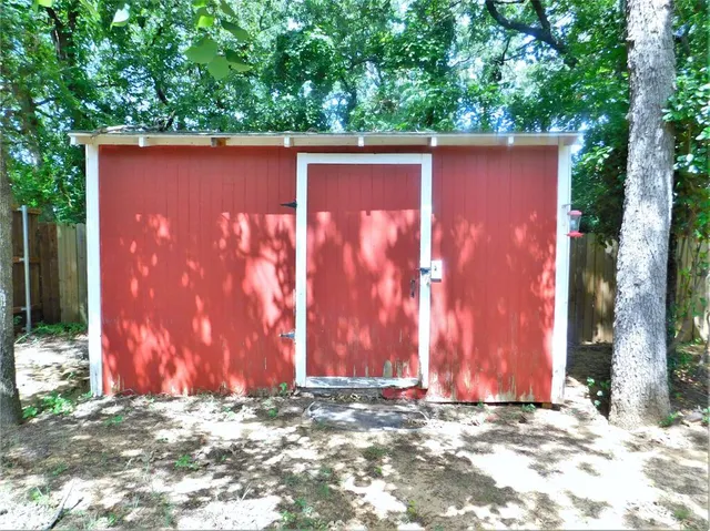 a front view of a house with a garden and yard