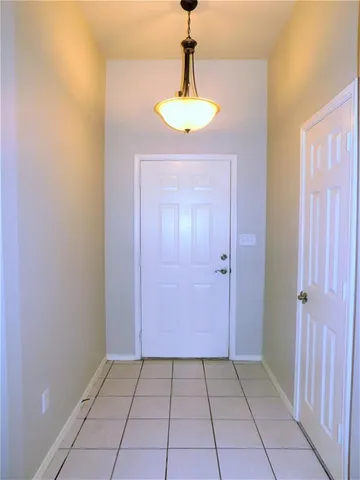 a view of an entryway with a chandelier fan