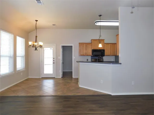 a view of a room with wooden floor and staircase