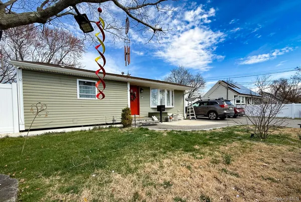 a kitchen with stainless steel appliances granite countertop a sink a stove top oven a refrigerator cabinets and a window