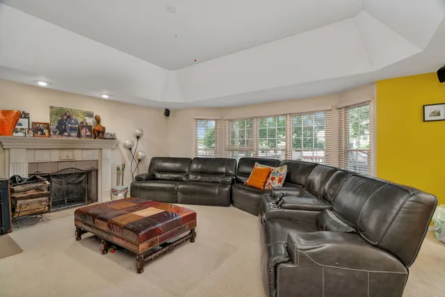 a living room with furniture a fireplace and a window