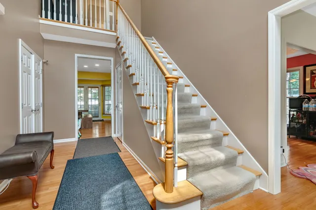 a view of entryway and hall with wooden floor