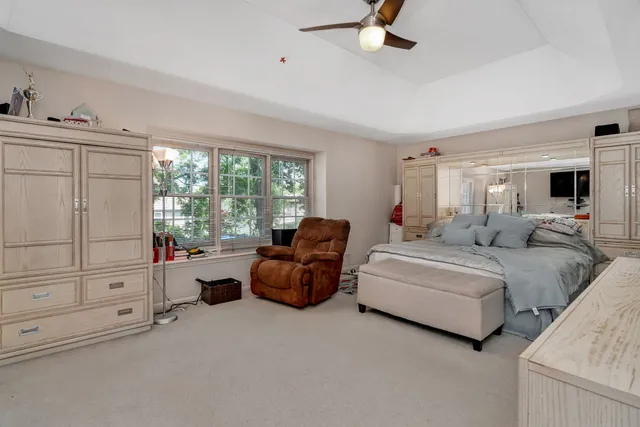 a bed room with furniture and a mirror