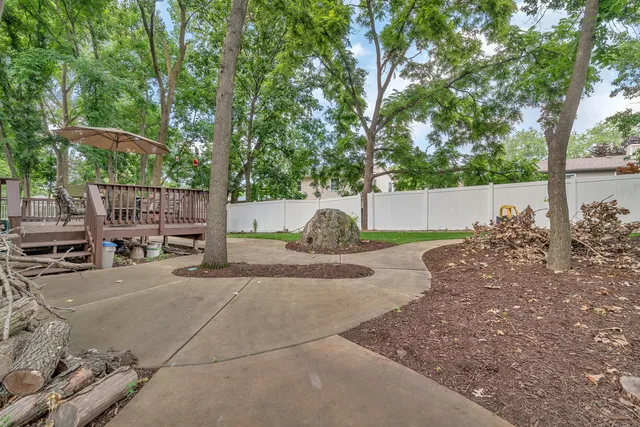 front view of a house with a yard and deck