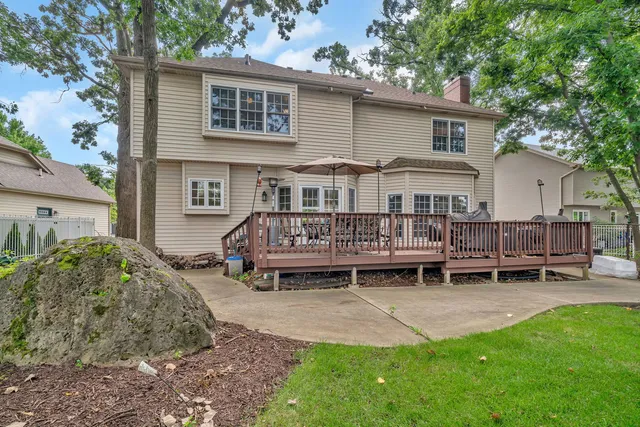 a view of a house with backyard and a deck