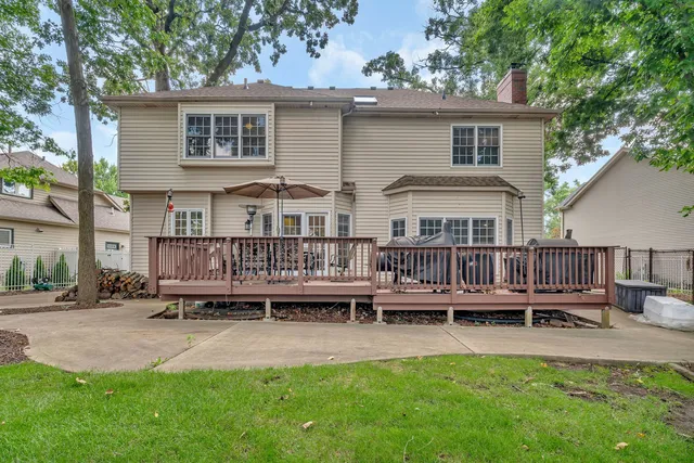 a view of a house with wooden deck and furniture