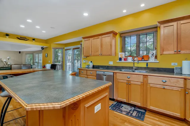 a kitchen with stainless steel appliances granite countertop a sink a stove and a refrigerator