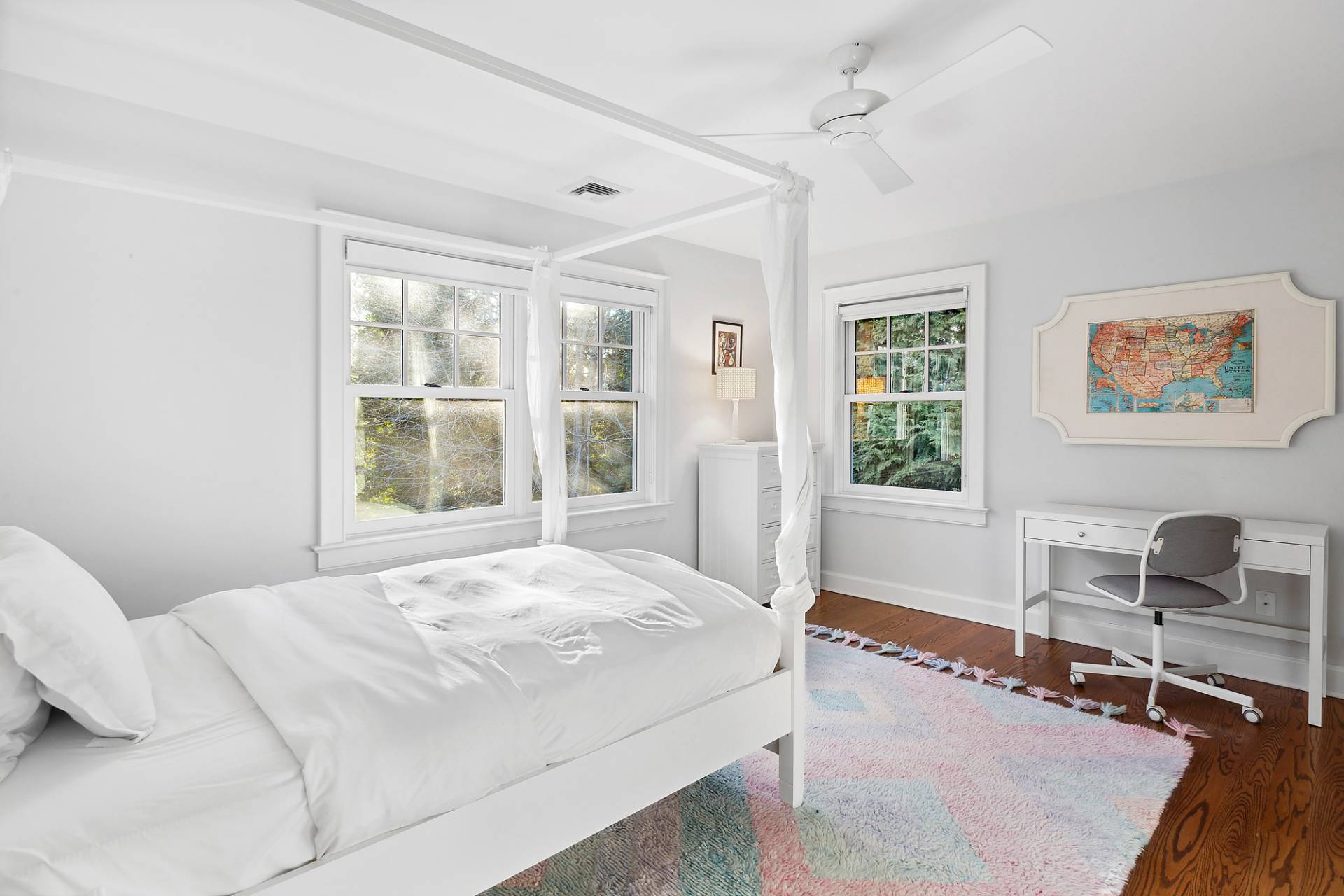 24 Peconic Bay Avenue Southampton, NY 11968 - Photo 12 of 18 a bedroom with a bed a table and windows