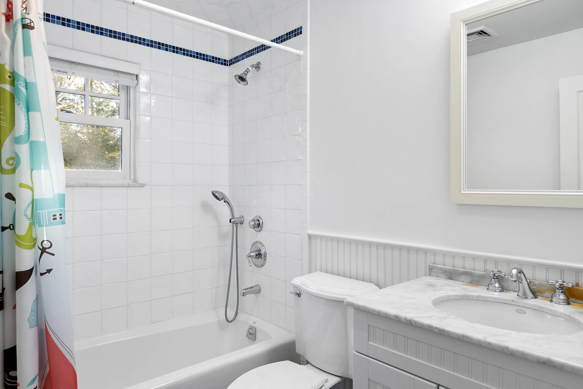 24 Peconic Bay Avenue Southampton, NY 11968 - Photo 13 of 18 a bathroom with a granite countertop bathtub shower sink vanity and toilet