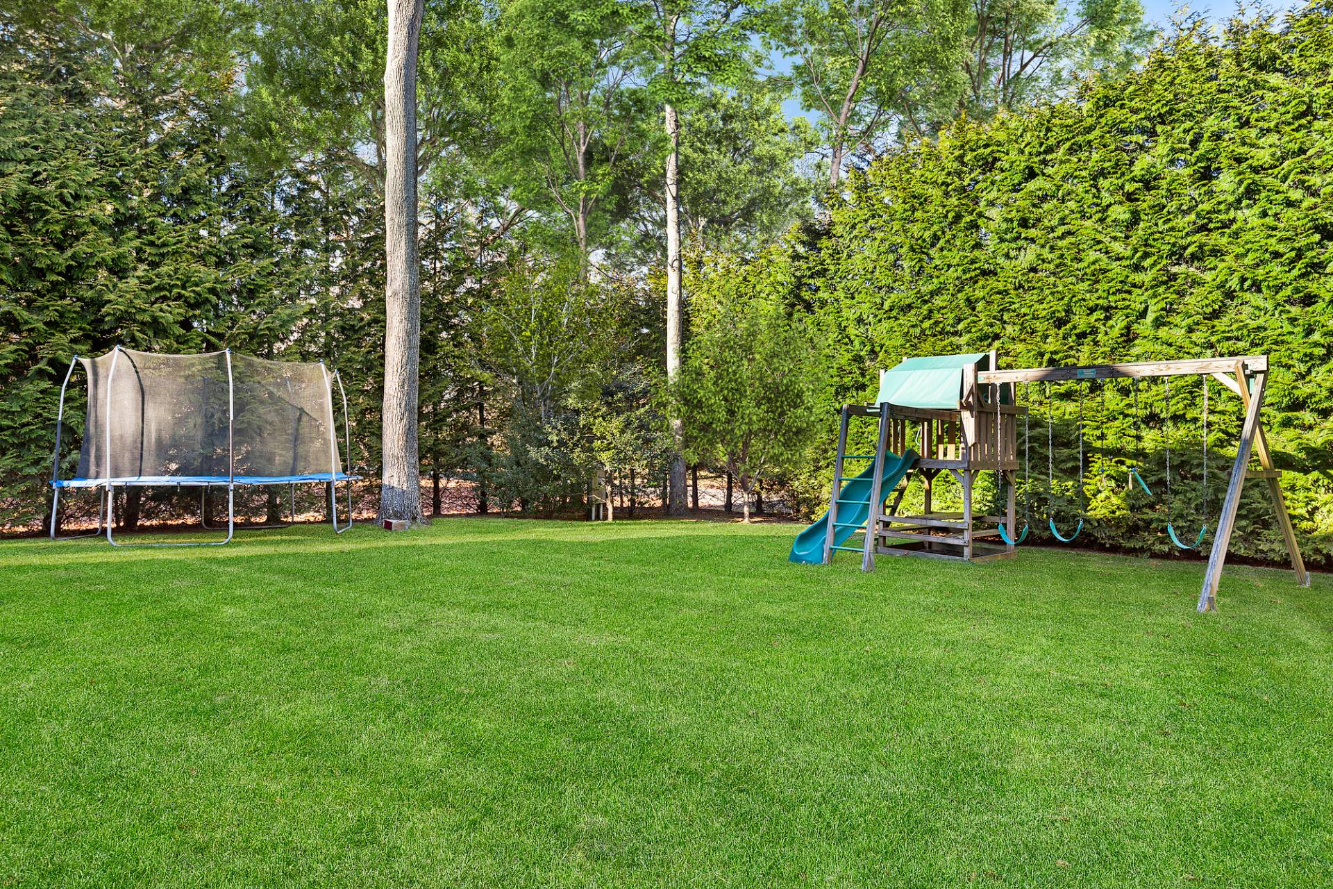 24 Peconic Bay Avenue Southampton, NY 11968 - Photo 17 of 18 a view of a park with swings