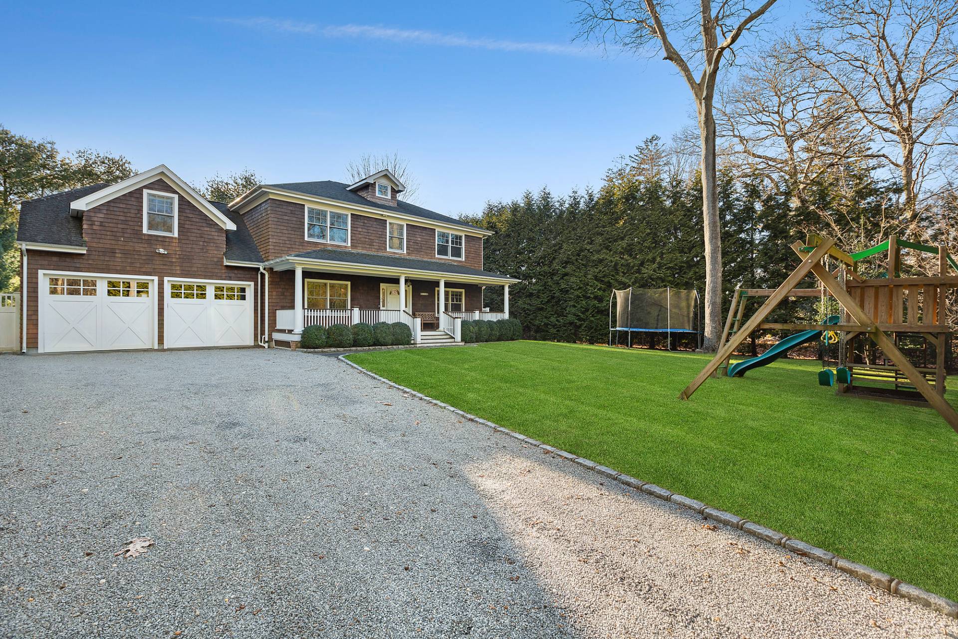 24 Peconic Bay Avenue Southampton, NY 11968 - Photo 18 of 18 a front view of a house with a yard