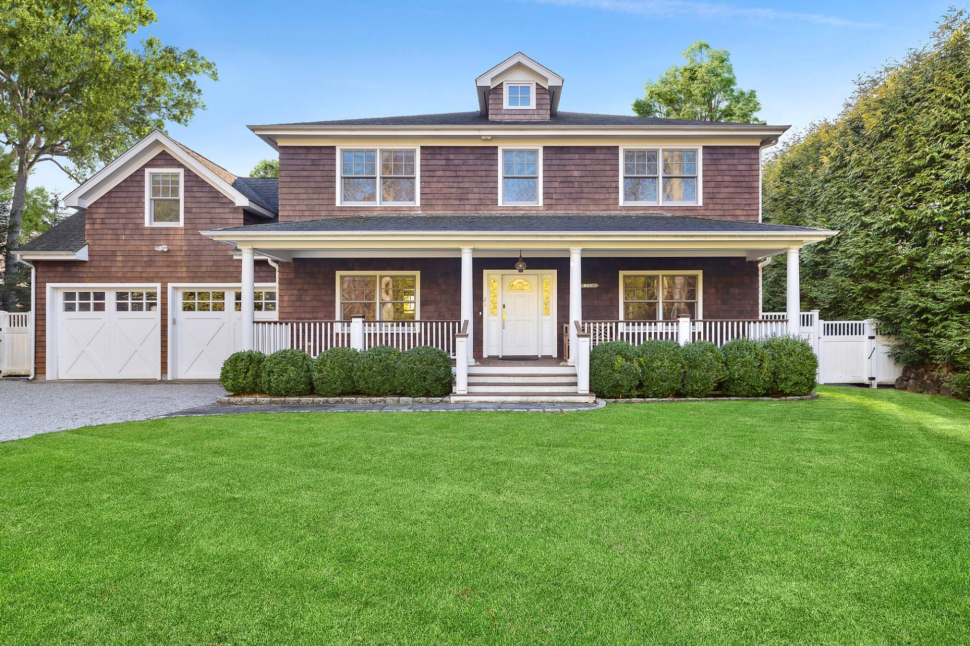 24 Peconic Bay Avenue Southampton, NY 11968 - Photo 2 of 18 a front view of a house with a yard