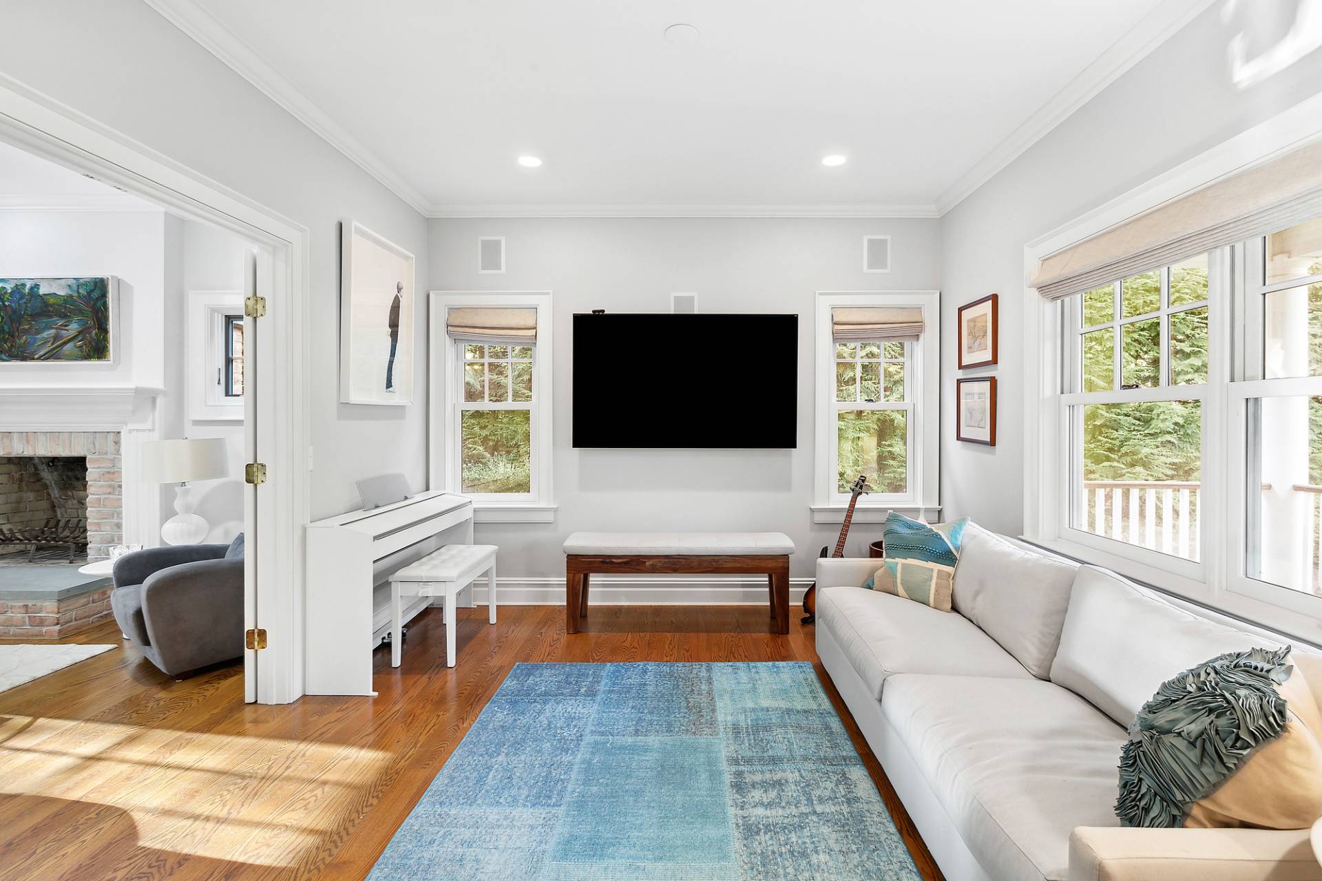 24 Peconic Bay Avenue Southampton, NY 11968 - Photo 6 of 18 a living room with furniture a flat screen tv and a fireplace