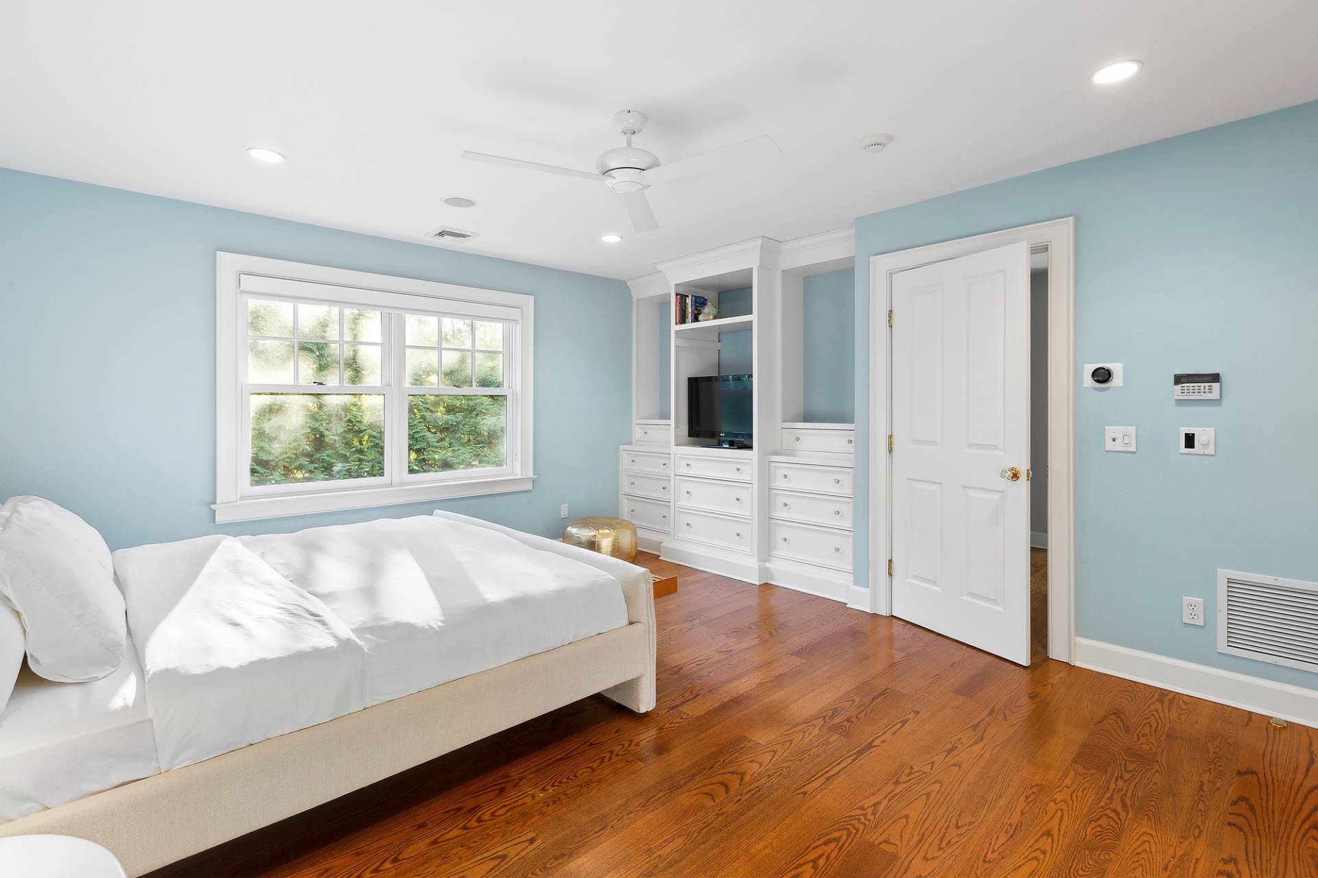 24 Peconic Bay Avenue Southampton, NY 11968 - Photo 8 of 18 a bed sitting in a spacious bedroom next to a window