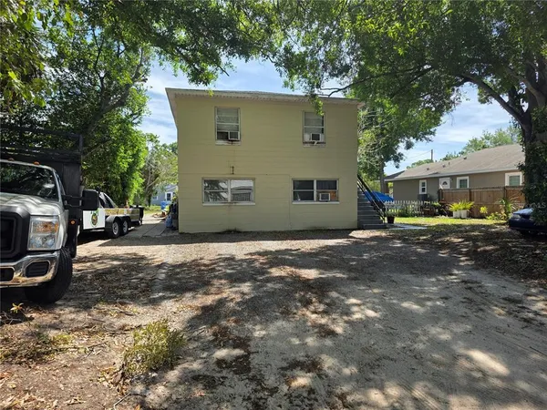 a view of a house with a yard and sitting area