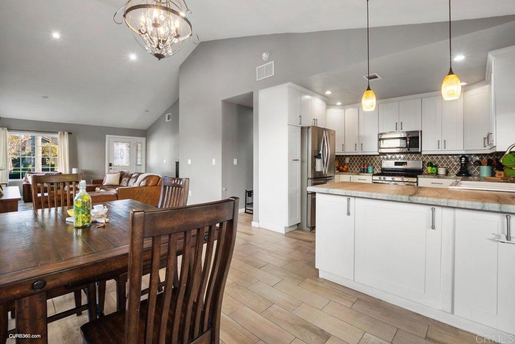 1963 Alderbrook Place Chula Vista, CA 91913 - Photo 11 of 30 a large kitchen with a table and chairs