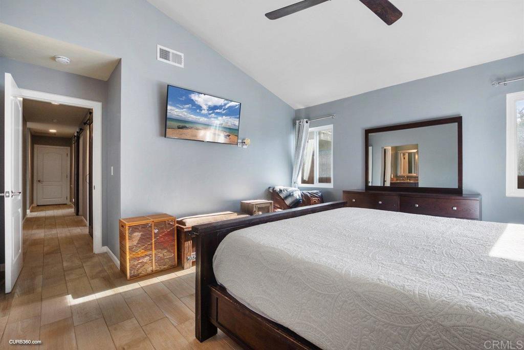 1963 Alderbrook Place Chula Vista, CA 91913 - Photo 13 of 30 a bedroom with a bed and a large mirror