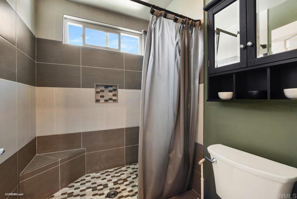 1963 Alderbrook Place Chula Vista, CA 91913 - Photo 16 of 30 a bathroom with a toilet a sink and shower