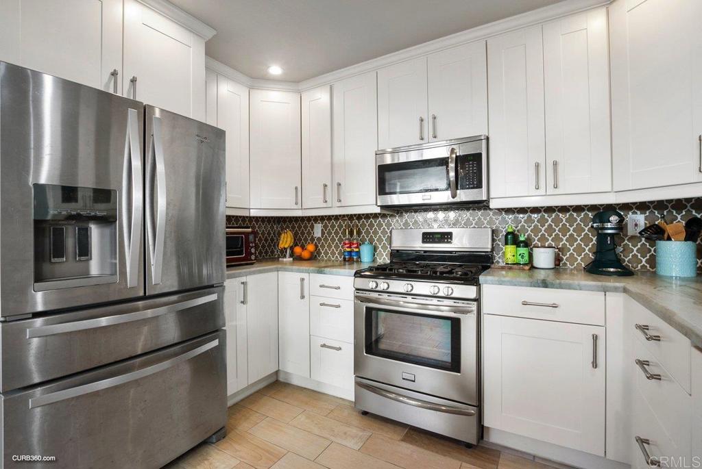1963 Alderbrook Place Chula Vista, CA 91913 - Photo 7 of 30 a kitchen with cabinets stainless steel appliances and a counter space