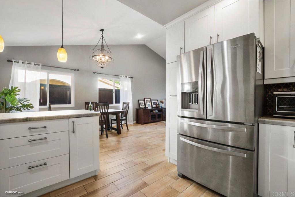 1963 Alderbrook Place Chula Vista, CA 91913 - Photo 9 of 30 a kitchen with stainless steel appliances a refrigerator sink and cabinets