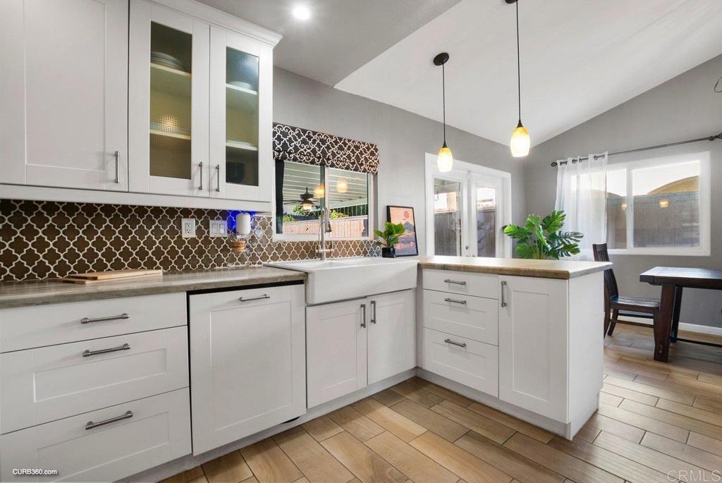 1963 Alderbrook Place Chula Vista, CA 91913 - Photo 10 of 30 a kitchen with white cabinets and a window