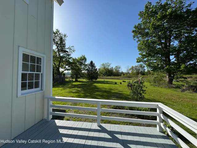 a view of a wooden deck and a yard