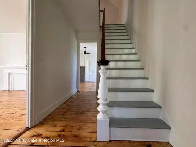 a view of entryway and hall with wooden floor