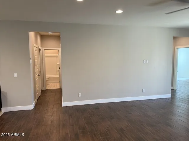 an empty room with wooden floor and closet