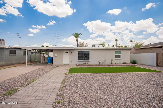 a front view of a house with a yard and a garage
