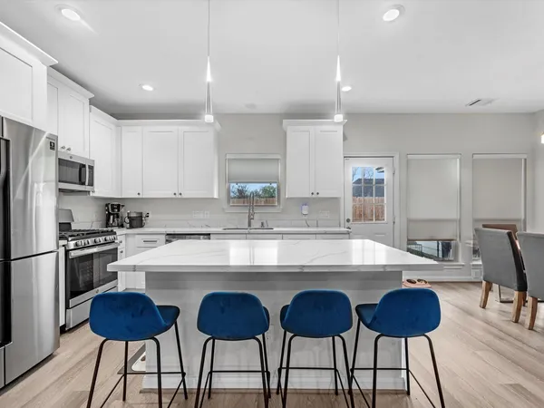 a large kitchen with cabinets and stainless steel appliances