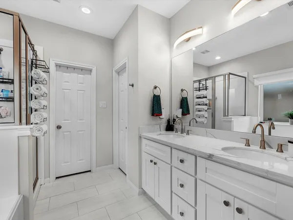 a large kitchen with stainless steel appliances kitchen island granite countertop a stove a sink and a refrigerator